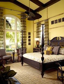 a bedroom with yellow walls and brown furniture