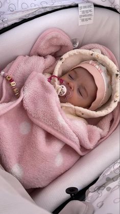 a baby wrapped up in a pink blanket