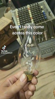 someone is holding an electric light bulb with the words even i really come across this color