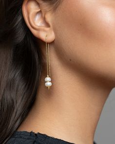 "Add a touch of elegance and sophistication to your ensemble with these stunning White Pearl Threaders. These versatile accessories are perfect for any outfit, featuring gold plating and delicately designed Pearl Drop Earrings. Ideal for weddings, these Bridesmaid Jewelry pieces will add a timeless charm to your bridal party. The Dangle Thread Earrings offer a unique and modern twist to traditional pearl jewelry while still maintaining a minimalist aesthetic. Elevate your style with these exquisite and contemporary Bridal Jewelry pieces that will make a statement. DETAILS  These earrings feature two natural pearl options, one in a baroque shape and the other in a flat button shape. They hang from a delicate 24k gold-plated sterling silver threader earring. Modern, elegant, and simple: thes Minimalist Pearl Chain Earrings For Formal Events, Minimalist Pearl Chain Earrings For Formal Occasions, Graceful Yellow Gold Wedding Earrings, Elegant Threader Earrings For Wedding, Delicate Linear Drop Earrings For Formal Occasions, Delicate Linear Earrings With Ear Wire For Formal Events, Delicate Linear Earrings With Ear Wire For Formal Occasions, Formal Gold Linear Earrings With Pearl Chain, Gold Linear Pearl Chain Earrings For Formal Occasions