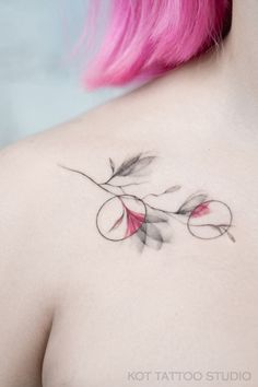 a woman with pink hair has a tattoo on her chest