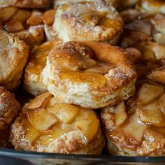 several pastries are piled on top of each other in a glass dish with powdered sugar