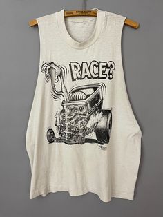 "Rat Fink Ed Roth The Rat trashed tank top, cut off sleeve T-Shirt,  RARE graphic \"Rat Race\" Hurst, tears, holes!  *very distressed, check photos for holes and tears TAG SIZE: n/a MATERIAL: n/a MEASUREMENTS LAYING FLAT in INCHES: SHOULDER TO SHOULDER: 13\" ARMPIT TO ARMPIT: 23\" LENGTH TO WAISTLINE: 24\" #618 IF YOU HAVE ANY QUESTIONS OR REQUESTS PLEASE FEEL FREE TO REACH OUT AND I WILL ACCOMMODATE YOU AS BEST I CAN! Cat" Retro Summer Tops With Back Print, Summer Muscle Tee With Screen Print And Crew Neck, Summer Screen Print Muscle Tee For Streetwear, Summer Muscle Tee With Crew Neck And Screen Print, Summer Grunge Muscle Tee With Crew Neck, Summer Graphic Tee Tank Top For Streetwear, Racerback Vest Top For Streetwear, Summer Grunge Tops With Back Print, Retro Muscle Tee With Graphic Print For Summer