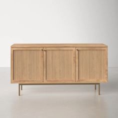 the sideboard is made out of wood and has two doors on one side, and three