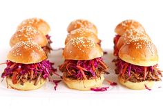 six pulled pork sliders with coleslaw slaw and sesame seeds on top