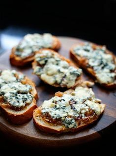 several pieces of bread with blue cheese on top