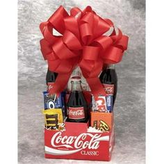 Nostalgia runs wild in the Coke Pack gift basket. The snacks America has loved for generations will take your special someone back to a simpler place and time. Classic Coke, childhood chocolate favorites, popcorn and Wrigley's gum will make you feel like a kid again. Make the day special with the Coke Pack gift basket. The Old Time Coke Gift Pack.Old Time Coke Pack - Small. Includes: 3 Classic Cokes Peanut M& M's Reese's Peanut Butter Cups Oreo Cookies Nestle Crunch Ba Cracker Jacks Microwave Popcorn Luden's Cherry Throat & Cough Drops Wrigley's GumSpecifications Size: Small Weight: 4 lbs - SKU: GFT338 Color: Multicolor. Coca Cola Gifts, Coke Gifts, Food Gift Basket, Snack Gift Baskets, Nestle Crunch, Reese's Peanut Butter Cups, Snack Gift, Teenager Gifts, Creative Diy Gifts