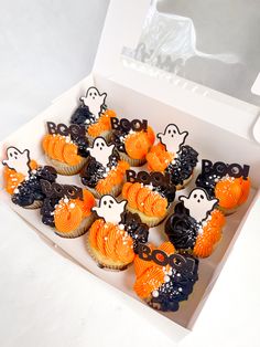 a box filled with cupcakes decorated like ghostes