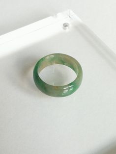 Green Natural Saddle Jadeite Ring Size 9 This saddle jadeite ring features contemporary craftsmanship is made from natural untreated Burmese jadeite. It is polished for a high shine. Dimension (in this picture): Inner diameter: 19.10 mm Thickness: 2.52 mm Width: 7.55 mm Weight: 17.42 carat Ring Size: US 9.0 Everything is handcrafted with exceptional care in Hong Kong. Item is wrapped in beautiful box! Styling & Care: - Avoid direct contact with harsh chemicals and steam - Clean with soft clo Handmade Green Jade Rings, Green Crystal Round Ring As Gift, Green Crystal Round Ring Gift, Green Crystal Round Ring For Gift, Handmade Green Crystal Ring, Green Crystal Round Promise Ring, Handmade Green Promise Ring, Green Round Crystal Promise Ring, Green Crystal Round Band Ring As Gift