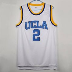 a basketball jersey hanging on a hanger with the number 2 in blue and yellow