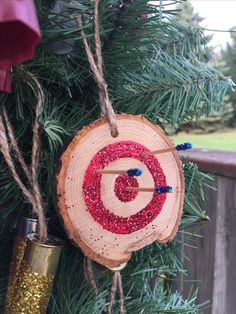 an ornament hanging from a christmas tree decorated with red and blue glitters