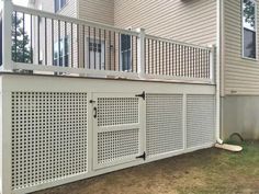 a white fence is next to a house