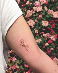 a small flower tattoo on the arm