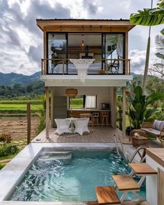 a house with a pool in the middle of it and some chairs on the outside