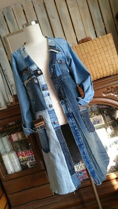 an old jean jacket is displayed on a mannequin in front of a mirror