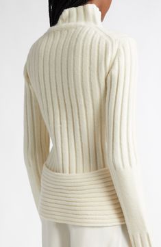 A curved back hem enhances the sculptural shape of this ribbed turtleneck sweater knit from a woolly, cashmere-enriched blend that offers exceptional warmth and comfort. 24" length (size Extra Small) Turtleneck Long sleeves 52% merino wool, 31% nylon, 11% cashmere, 6% spandex Dry clean or hand wash, dry flat Imported Designer Clothing Fitted Turtleneck Cardigan With Textured Knit, Fitted Ribbed Turtleneck Cardigan, Elegant Ribbed Wool Turtleneck, Fitted Turtleneck Cardigan With Ribbed Collar, Elegant Fitted Textured Knit Turtleneck, Fitted Funnel Neck Sweater With Ribbed Neckline, Chic Ribbed Merino Wool Sweater, Fitted Merino Wool Sweater With Ribbed Neckline, Fitted Ribbed Cashmere Cardigan