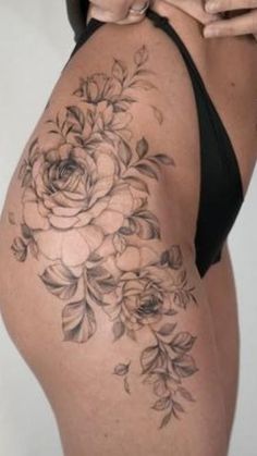 a woman's back with flowers on it and the bottom half of her body