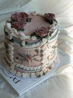 a three tiered cake on top of a book