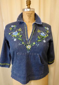 "Hand embroidered and embellished denim fabric shirt. Original freestyle design embroidered by Vermont artist Debbi Wetzel, \" is like painting with thread \" Gloria Vanderbilt label   guesstimate   size M  displayed  on size 20 dress form measures 23\" length  18\" sleeve length and 17\" across back kangaroo pocket across front  buttons ,beads and colorful embroidery threads clean and ready to wear..you will have the only one ! Happy to gift wrap and enclose card upon request sorry no returns" Embroidered Long Sleeve Denim Top For Summer, Medium Wash Floral Embroidered Cotton Denim Top, Fitted Embroidered Medium Wash Tops, Embroidered Long Sleeve Denim Top For Spring, Floral Embroidery Cotton Denim Top In Medium Wash, Blue Denim Top With Floral Embroidery For Spring, Embroidered Denim Blue Cotton Tops, Embroidered Medium Wash Denim Cotton Top, Vintage Embroidered Denim Blue Tops