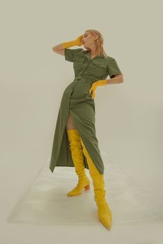 a woman wearing yellow boots and a green dress