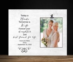 a wooden frame with an image of two women in wedding dresses and the words today a bride