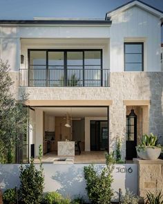 a modern house with an outdoor kitchen and dining area