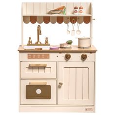 a white wooden play kitchen with an oven, sink and stove top on a white background