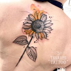 a sunflower tattoo on the back of a woman