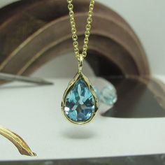 The Necklace And The Pendant Made From 14 Karats Solid Yellow Gold. Chain Length 17.7inch/ 45cm'. Aquamarine Stone House: 0.5x0.6inch/ 12x15mm'. Necklace For Women. Necklace For Men. Special Gold Necklace Bezel Set With A Pear-Shaped Blue Aquamarine. Hand-Made One Of A Kind. This Necklace Is So Simple, Delicate, And Timeless, A Gift That Each Woman Likes To Have. Chain Available In All Sizes, Color Gold And Karat, And Matte Or Shining Finish. Each Pendant Is Custom-Made, Unique, And Will Have Sl Luxury Blue Teardrop Pendant Necklace, Gold Blue Topaz Teardrop Pendant, Luxury Blue Teardrop Pendant Jewelry, Teardrop Blue Topaz Jewelry In Yellow Gold, Teardrop Blue Topaz Yellow Gold Jewelry, Yellow Gold Teardrop Blue Topaz Jewelry, Blue Topaz Drop Necklaces, Blue Teardrop Pendant Necklace With 17 Jewels, Blue Drop Necklaces With Blue Topaz