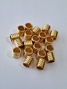 gold plated metal fittings on a white surface with space for text or image