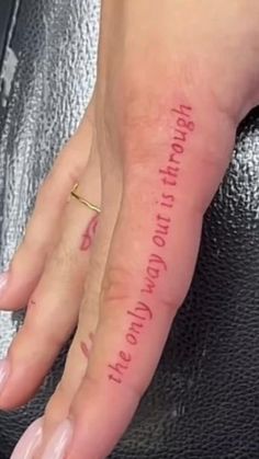 a woman's hand with a small tattoo on her left thumb and the words, you