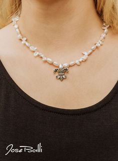 Two waves create this beautiful fleur de lis on a white keshi pearl necklace, representing the most iconic symbol of New Orleans. · Sterling silver · Freshwater keshi pearls · 18" length · Water lily 1"L x 7/8"W · Handcrafted toggle clasp · Made in New Orleans · 1 year warranty · Complimentary gift packaging · Free shipping · Free catalog · Free postcard designed by Jose · Free biography card about Jose Diamond Necklace