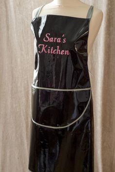 a mannequin wearing a black apron that says sara's kitchen