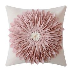 a pink pillow with a large flower on it