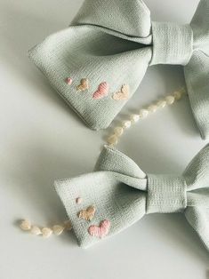 two bow ties with seashells on them