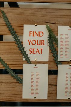 three pieces of paper with words on them hanging from the side of a wooden wall