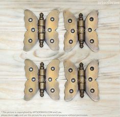 four antique brass butterfly cabinet pulls