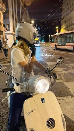 a woman riding on the back of a white scooter