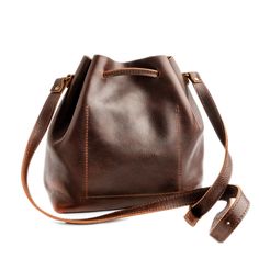 Simple things are often the best. Our minimalist leather Bucket Bag is an effortless crossbody you'll want to grab every day. Featuring a relaxed leather drawstring opening, allowing plenty of space to carry all of your essentials, and a sleek inside pocket. The crossbody adjustable strap assures a perfect fit every time. Available in two sizes. No two PLG bags are alike! Please note: it is normal for all of our products, including Premium items, to have unique variations and character markings Character Markings, Simple Purse, Shoe Repair Shop, Portland Leather Goods, Raw Leather, Leather Bucket Bag, Almost Perfect, Leather Bucket, Simple Things