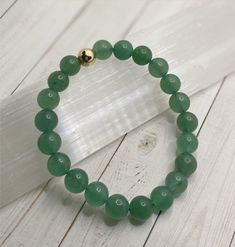 *GREEN AVENTURINE FOR ABUNDANCE AND CAREER SUCCESS* Green Aventurine is one of the luckiest stones. It helps to manifest prosperity, abundance and success. It aids in healing emotions from childhood trauma. **FOR HEART CHAKRA MEDITATION** INCLUDES: 1 Green Aventurine beaded stretch bracelet with 14K gold filled spacer (8mm Beads) 1 Description/Affirmation Card *ALL BRACELETS ARE HANDMADE WITH LOVE LIGHT AND POSITIVE INTENTION* Green Gemstone Stretch Bracelet Gift, Green Jade Crystal Bracelet For Meditation, Green Jade Stretch Bracelet For Meditation, Green Spiritual Stretch Bracelet For Healing, Green Aventurine Crystal Bracelet With Natural Stones, Adjustable Green Aventurine Crystal Bracelet, Green Aventurine Stretch Bracelet With Natural Stones, Green Gemstone Crystal Bracelet For Meditation, Everyday Spiritual Aventurine Bracelets