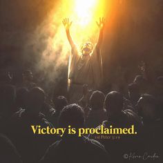 a man standing in front of a crowd holding his hands up with the words victory is proclaimmed