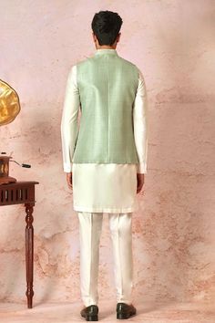 Mint green bundi with vintage jaal pattern, contrast dori and lurex badla embroidery. Paired with cream full sleeve kurta and pant style pyjama. - Aza Fashions Traditional Sleeveless Green Nehru Jacket, Sleeveless Green Traditional Nehru Jacket, Fitted Green Bandhgala For Spring, Spring Green Fitted Bandhgala, Fitted Green Nehru Jacket For Spring, Green Fitted Nehru Jacket For Spring, Green Sleeveless Fitted Nehru Jacket, Badla Embroidery, Badla Work