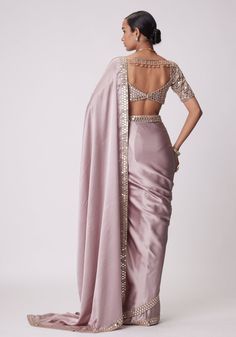 Buy Pink Satin Saree With Embroidered Mirror Blouse by Vvani by Vani Vats at Fabilicious Fashion! Shop made-to-measure Indian wedding wear and jewellery with fast shipping to USA, UK, and Canada. Pink Blouse With Mirror Work For Eid, Pink Semi-stitched Choli For Evening, Pink Semi-stitched Evening Choli, Satin Pre-draped Saree For Reception, Elegant Satin Pre-draped Saree With Pallu, Satin Pre-draped Saree With Pallu For Reception, Pink Pre-draped Saree With Zari Work For Evening, Evening Traditional Wear With Mirror Work In Art Silk, Silk Pink Blouse With Mirror Work