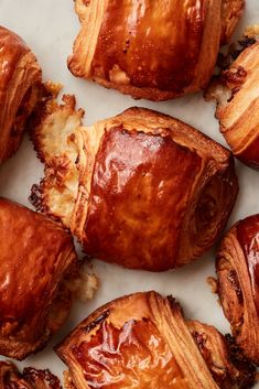 some very tasty looking pastries that are on a white counter top with one bite taken out