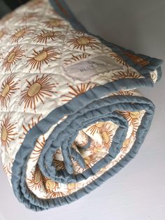 an orange and blue blanket laying on top of a white table