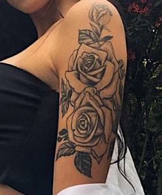 a woman's arm with a rose tattoo on her left shoulder and the other half sleeve