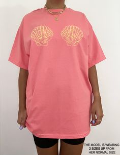 We are loving our latest coconut girl oversized tee! It gives total sirencore & mermaidcore vibes! This cotton tee has the classic cotton look and feel and fits like a well-loved favorite. It's soft, cozy, and a great trendy addition to your wardrobe! Super soft cotton and excellent quality print makes you fall in love with it over and over again. This is garment is digitally printed which means it isn't vinyl or glossy. It's the same quality as the shirts you purchase from your favorite stores! Pink Oversized Top For Beach, Pink Oversized Tops For Beach Season, Pink Oversized Top For Beach Season, Oversized Tops For Beach Season Streetwear, Pink Oversized T-shirt For Beach Season, Oversized Pink T-shirt For Beach Season, Oversized Pink Graphic Tee Shirt, Oversized Pink Summer T-shirt, Oversized Pink Top For Beach