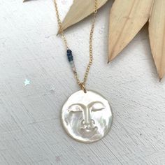 "The day I decided that my life was magical, there was suddenly magic all around me" Marabeth Quin Moonchild, this magical piece is for you! Wear it as a reminder that there is a little bit of magic in all of us and let your light shine bright. An absolutely stunning and intricately carved mother of pearl moon face is hung on your choice of sterling silver or 14kt gold fill chain and accented with six micro-faceted gemstones in tones ranging from dark blue to crystal clear, This stunning stateme Shell Charm Necklace, Boho Moon, Bee Studs, Face Necklace, Moon Face, Let Your Light Shine, Seashell Necklace, Cowrie Shell, Faceted Gemstones