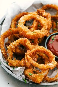 fried onion rings with ketchup on the side