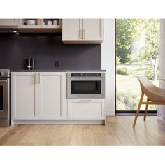 a kitchen with an oven, stove and dining room table in the backround